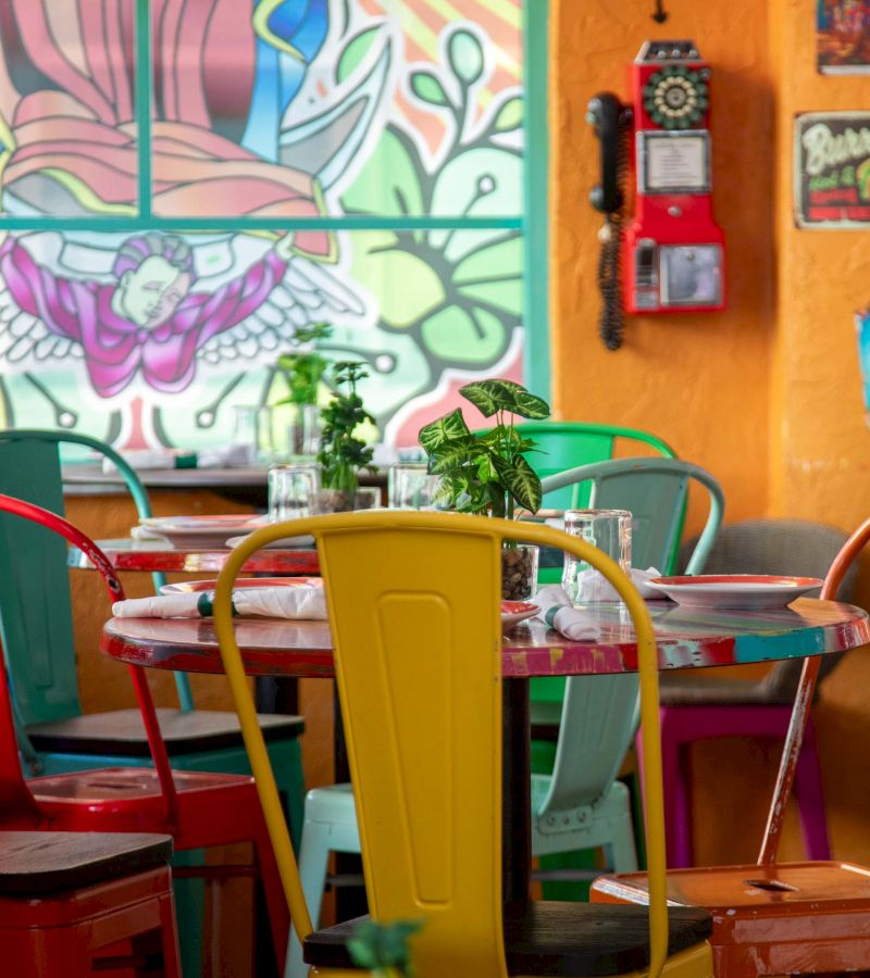 A colorful restaurant dining area with tables and chairs